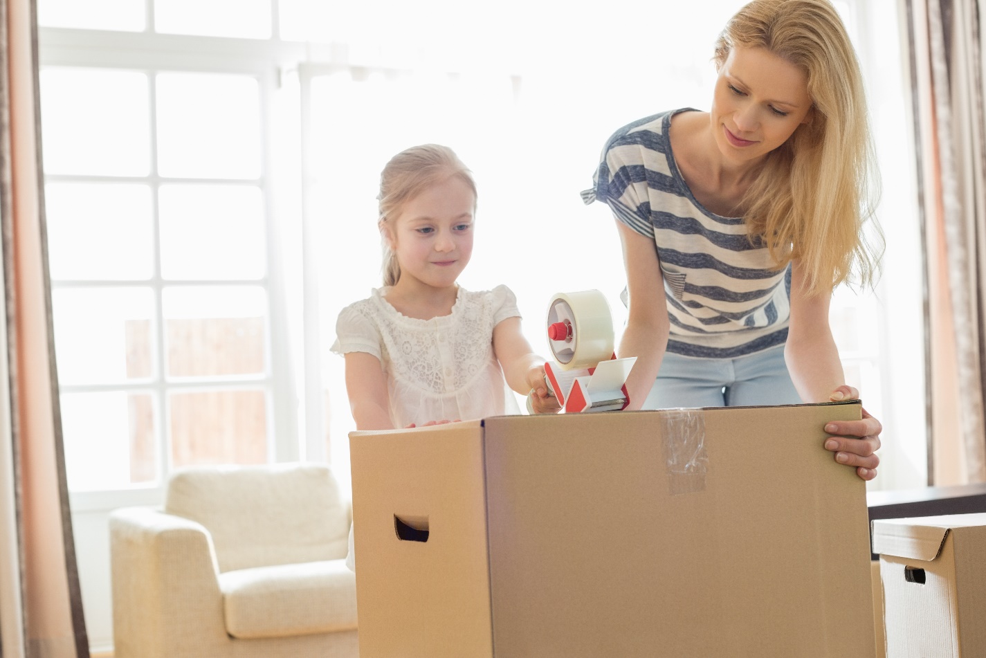 mother and child packing a box