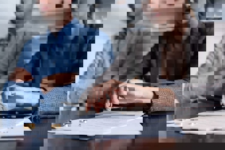 Ex-partners reviewing paperwork for a spousal support modification