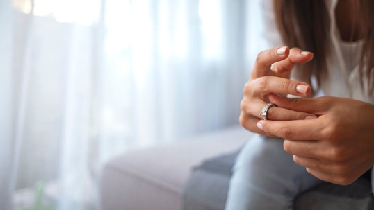 Woman looking at wedding ring on finger