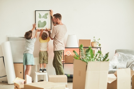 father and children unpacking