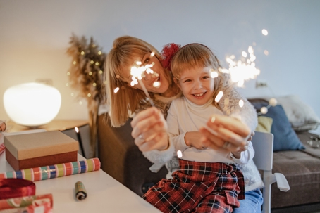 mother and daughter playing with sparklers