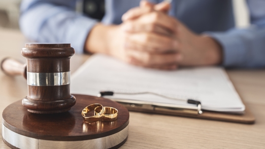 person about to sign divorce papers in law office