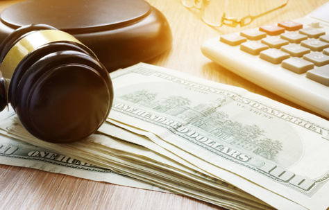 money, a gavel, and a calculator