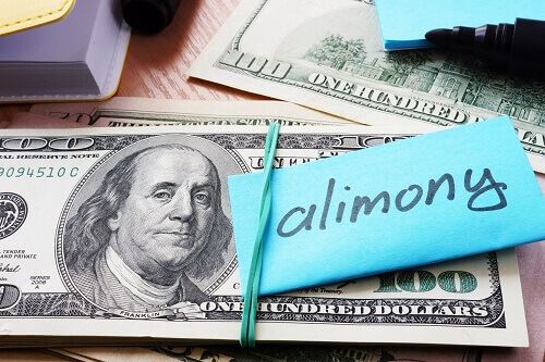Stack of hundred dollar bills and a note that says