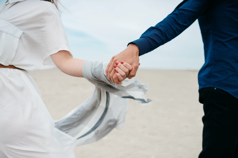 Close up of a woman holding hands with a man in San Diego.